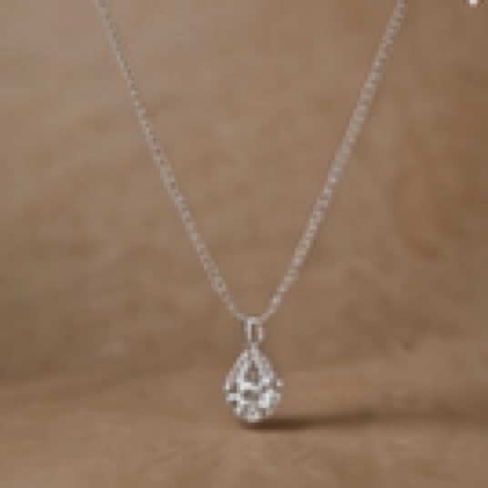 Teardrop pendant necklace on a model